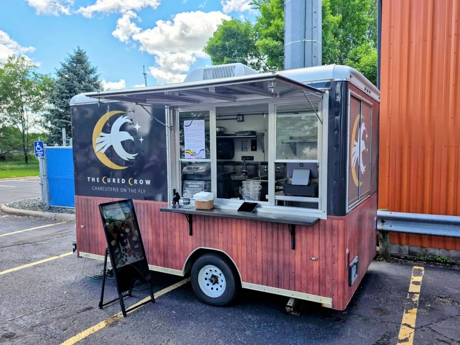 The Cured Crow charcuterie trailer set up outside for a brewery or taproom event